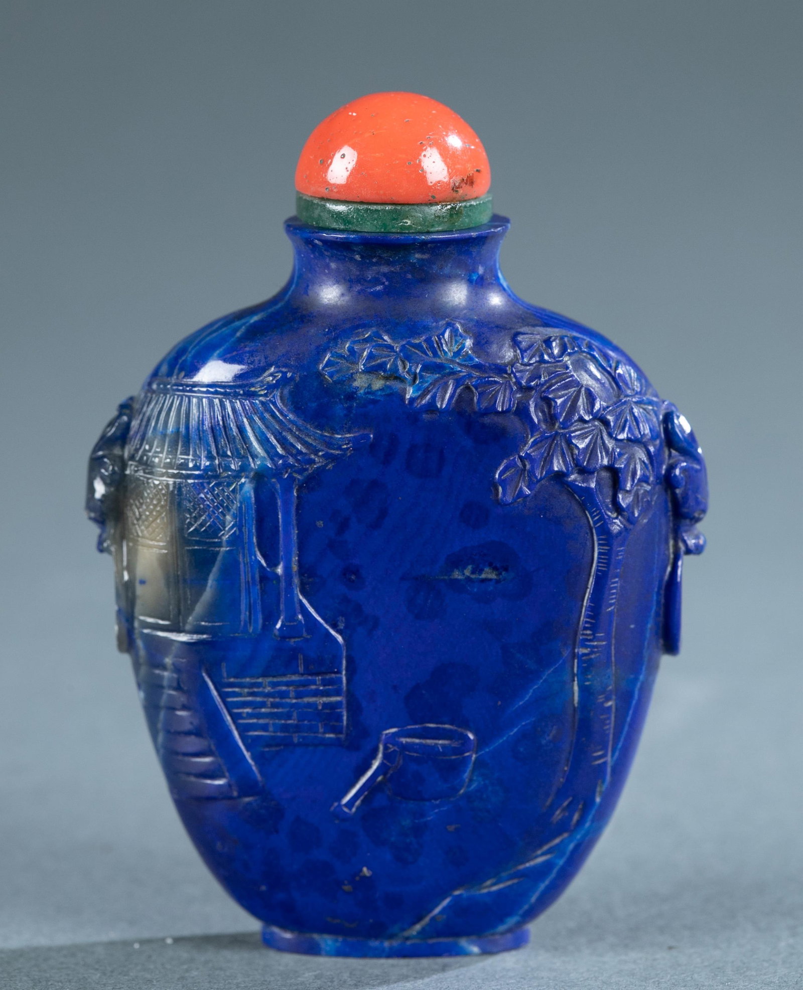 Chinese lapis snuff bottle, 19th/20th c.: A Chinese lapis snuff bottle, Late 19th/20th Century. Finely depicted with Chinese traditional legends, an ancient Chinese yard and a flying fairy. With a coral stopper. 2 7/8" x 2 1/8". Condition: Co