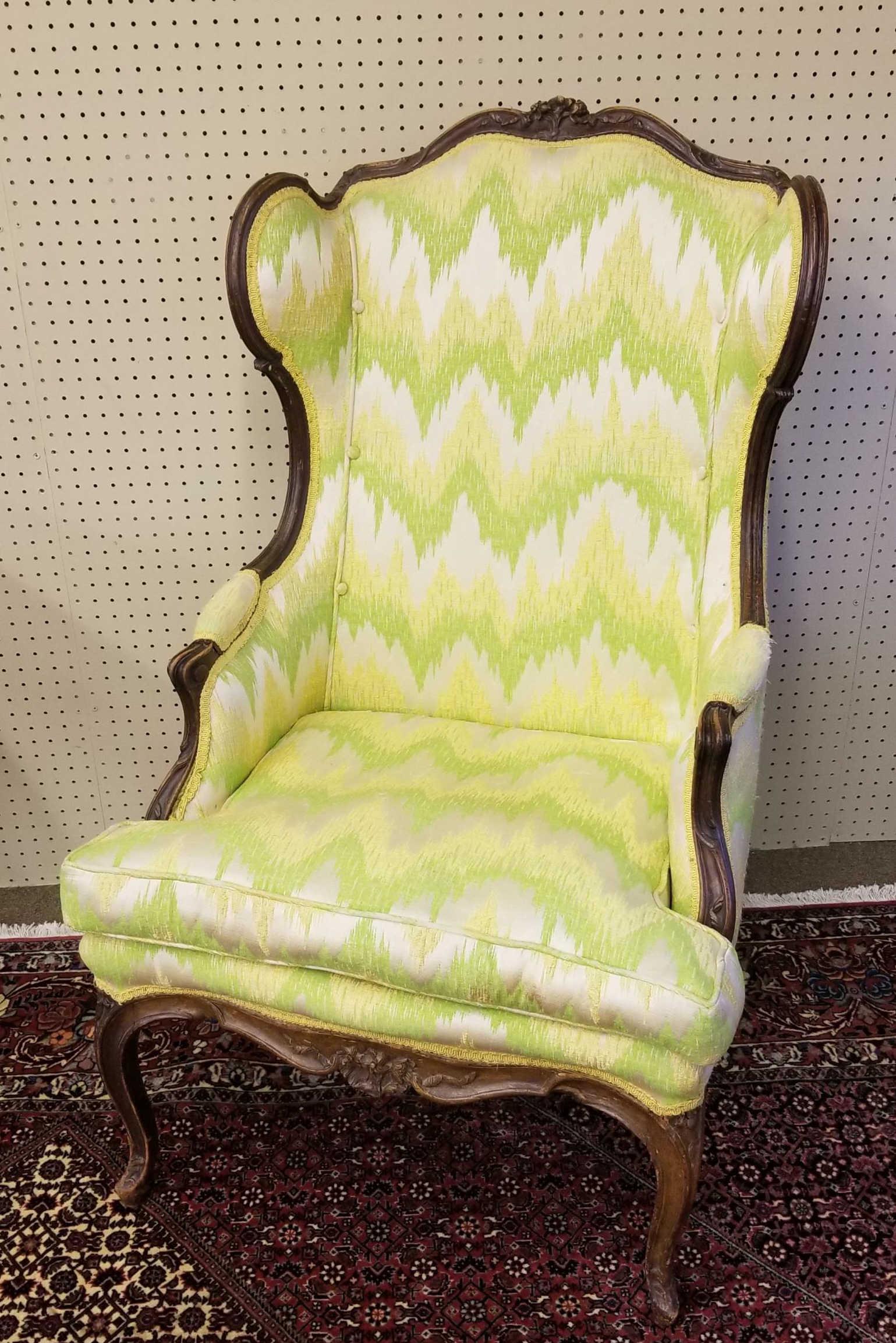 Two French Louis XV style bergere arm chairs.: A group of two French Louis XV style bergere arm chairs. ++ Louis XV style wing back bergere chair, early 19th c. Foliate carved crest, upholstered back, wings and arms, raised on cabriole. 46" x 27" 
