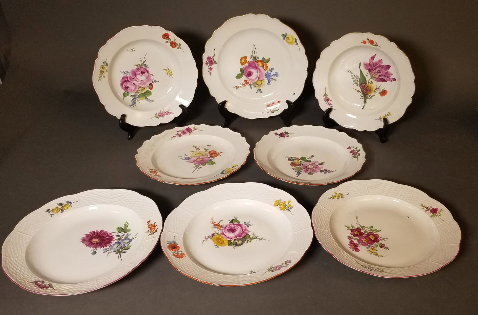 8 Meissen porcelain pieces, 18th c.: A group of eight Meissen scalloped edge floral porcelain bowls and plates, circa 1774-1815. This includes two 9 1/4" red rim dinner plates, one 9 1/2" deep dinner plate, one 9" gold rim bowls, deep bo