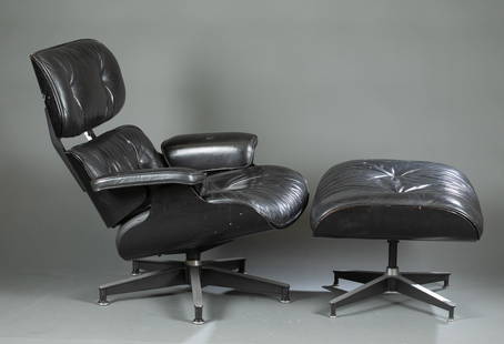 Eames for Herman Miller chair and ottoman.: An Eames 670 lounge chair and 671 ottoman designed for Herman Miller. Black veneered shell and black leather upholstery and enameled aluminum frame. Each have decal and manufacturer's label on