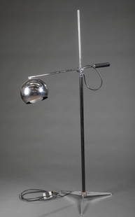 Sonneman style chrome eyeball floor lamp.: A Sonneman style chrome eyeball floor lamp. Swing arm style to adjust height and foot switch on power cord. 20th century. 28 1/2" x 58 1/8".Condition: Residue on shade, light scratches to stand and