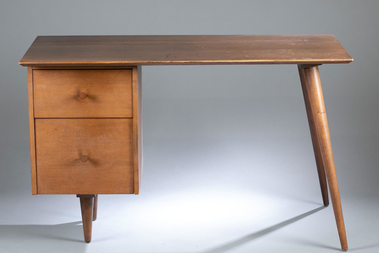 Paul McCobb Planner Group desk.: A Paul McCobb ( American, 1917-1969) Planner Group teak desk for Winchendon Furniture Company, circa 1949-1964. Two drawers with wood pulls. 29 1/2" x 48" x 24"Condition: Staining and scuffs on top of