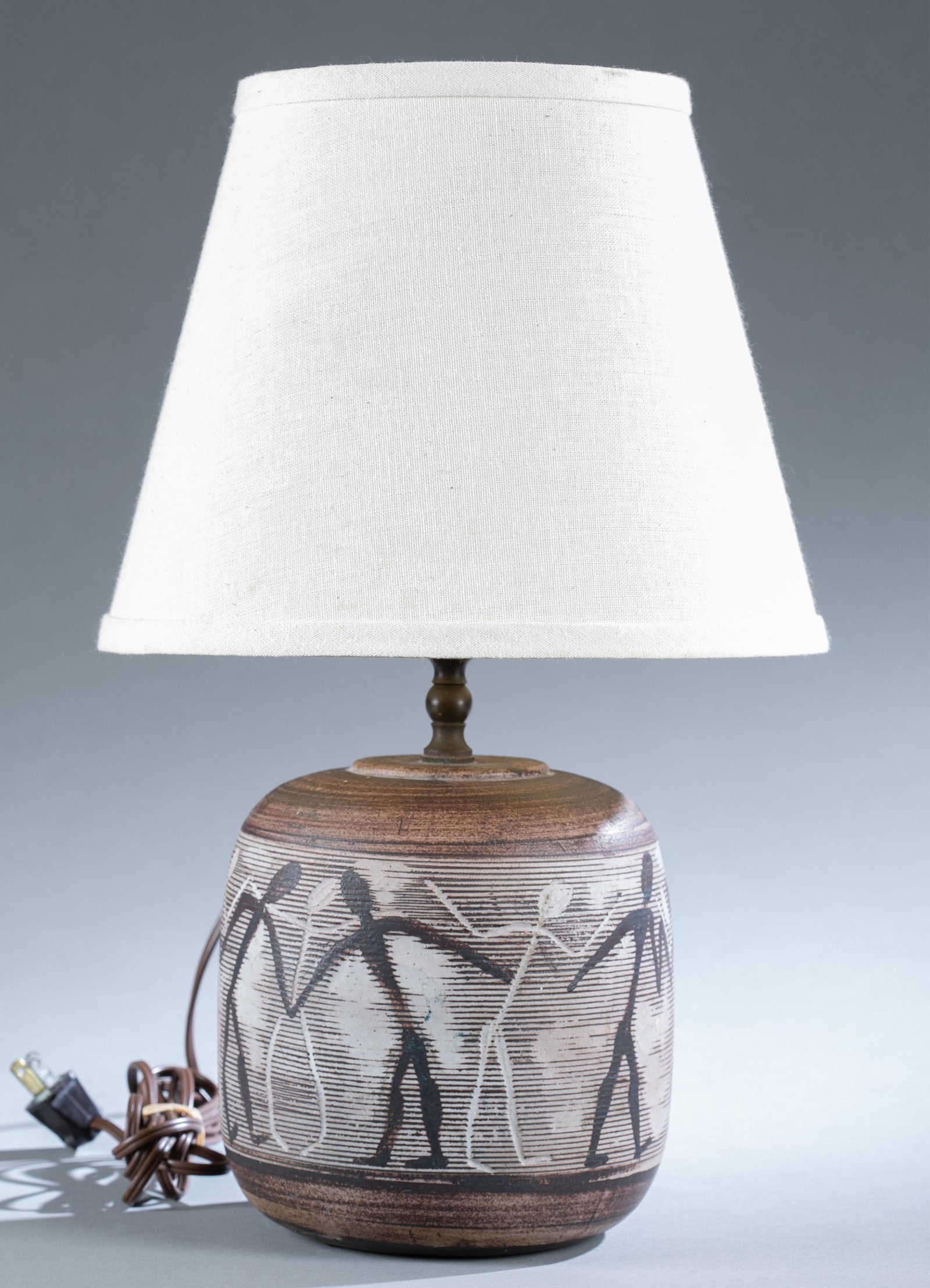 Nancy Wickham Boyd ceramic lamp.: Wickham Boyd, Nancy (American b. 1923) glazed ceramic lamp with incised figural design. Incised signature on base. Without shade: 15 3/4" x 6 1/2". Comes with shade