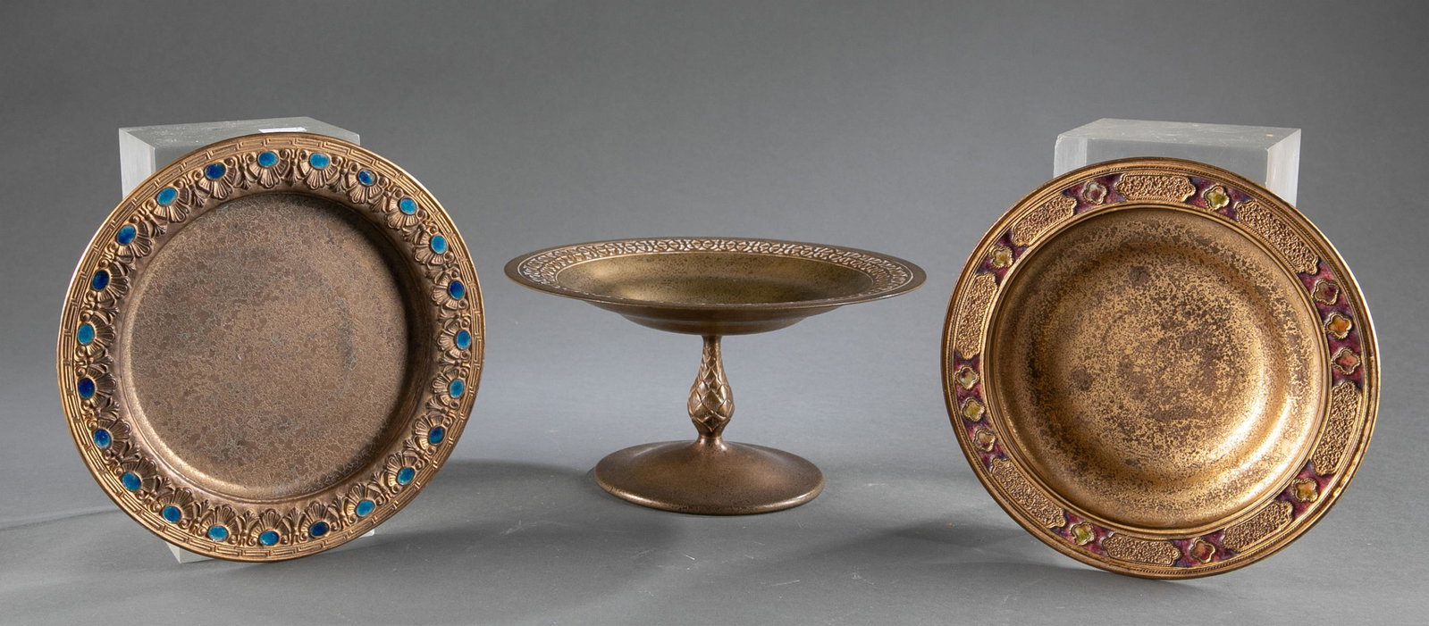 3 Tiffany Studios gold dore pieces.: A group of three Tiffany Studios gold dore pieces. ++ Tiffany Studios gold dore compote, circa 1902–32. Marked underside of lip "Tiffany Studios/ New York/ 1664." 4 1/2" x 9". ++ Louis C. Tiffany Fu