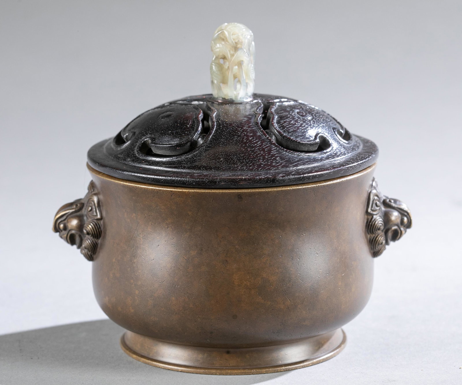 Chinese bronze censer, Xuande Mark.: A Chinese bronze censer/incense burner, having figural foo dog handles. Bottom holds impressed six characters "Daming Xuande Nianzhi" and possibly from Ming dynasty. Comes with a black wood cover, a j