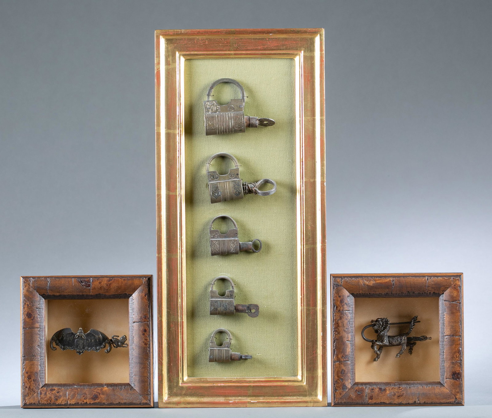 3 Framed Chinese bronze lock collections.: A group of three Chinese bronze lock collections. ++ A bat shape bronze lock. Well framed. 1 1/4" x 3 1/2". Frame: 6 3/8" x 6 1/4" x 2 1/4". ++ A Kirin shape bronze lock, the lock cylinder goes throug
