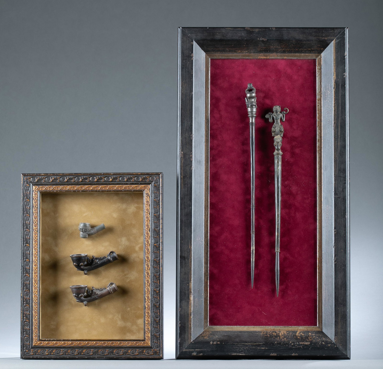 2 Framed metal collections, 19th c.: A group of two framed bronze collections, 19th century. Including 2 Burmese brass tattooing instruments, 19th century. Well framed. One with a carved human lying down to the head. Other with a carved 
