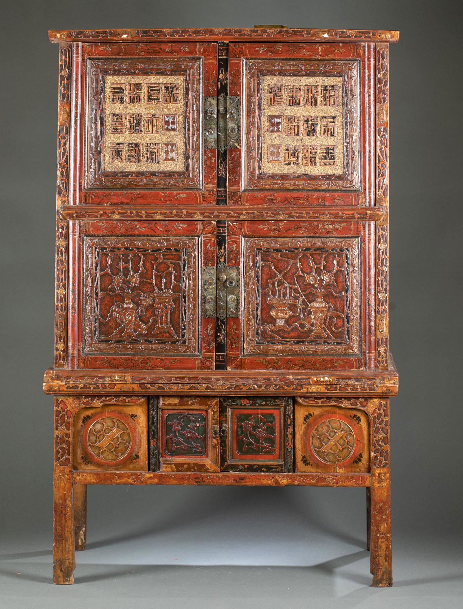Antique Chinese carved chest.: An antique Chinese carved chest. Large cabinet with three-level small square panel compartments. Each upper compartment has 10 carved characters with 2 seals. The middle compartments have carved vases