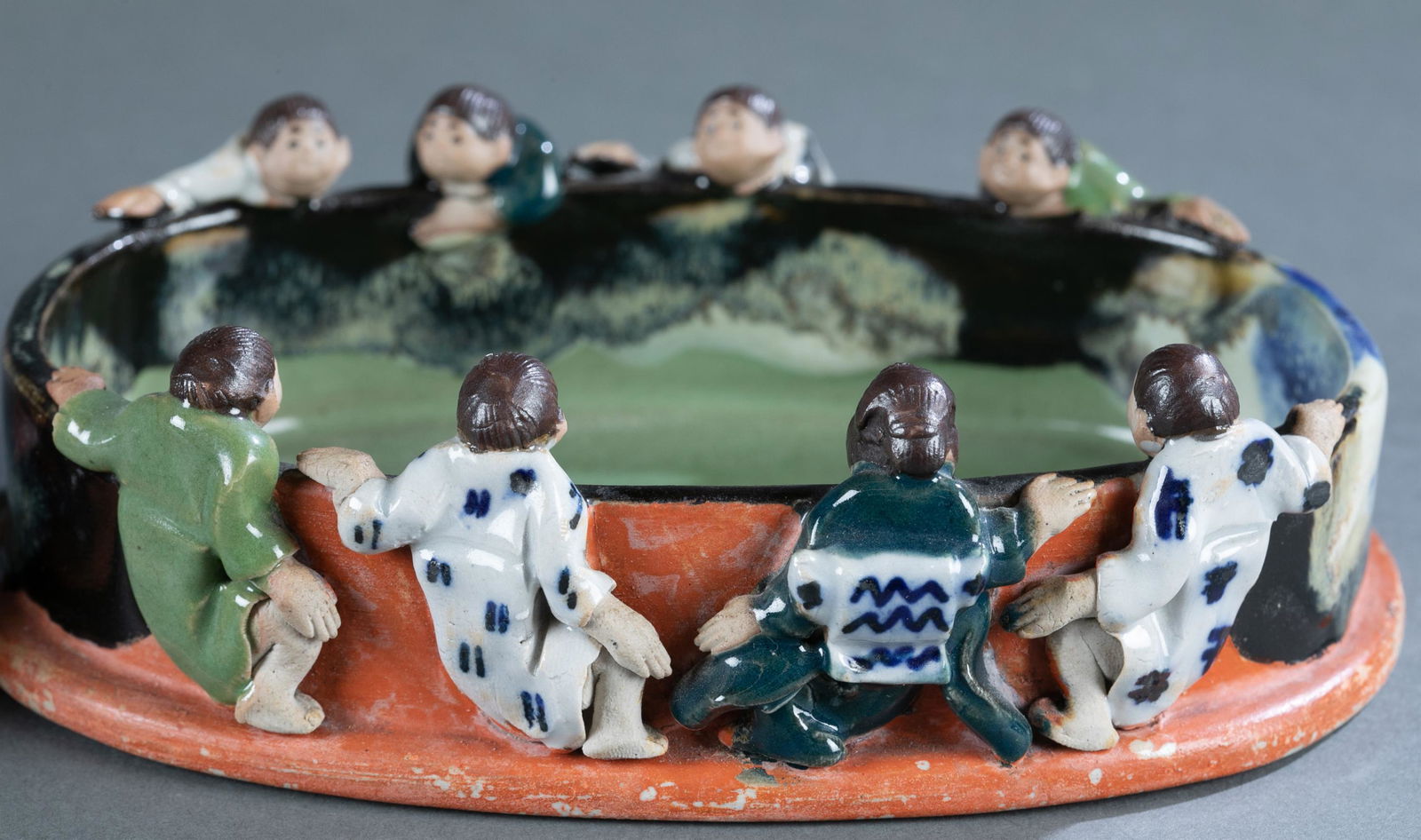 2 Sumida Gawa dishes with figures on the edge.: 2 Sumida Gawa dishes with figures on the edge. Including one larger dish, 8 figures climbing on the edge. 2" x 7" x 4 3/4". One smaller dish, 6 figures on the edge. 2" x 5 3/4" x 4 3/8". Unsigned.Cond