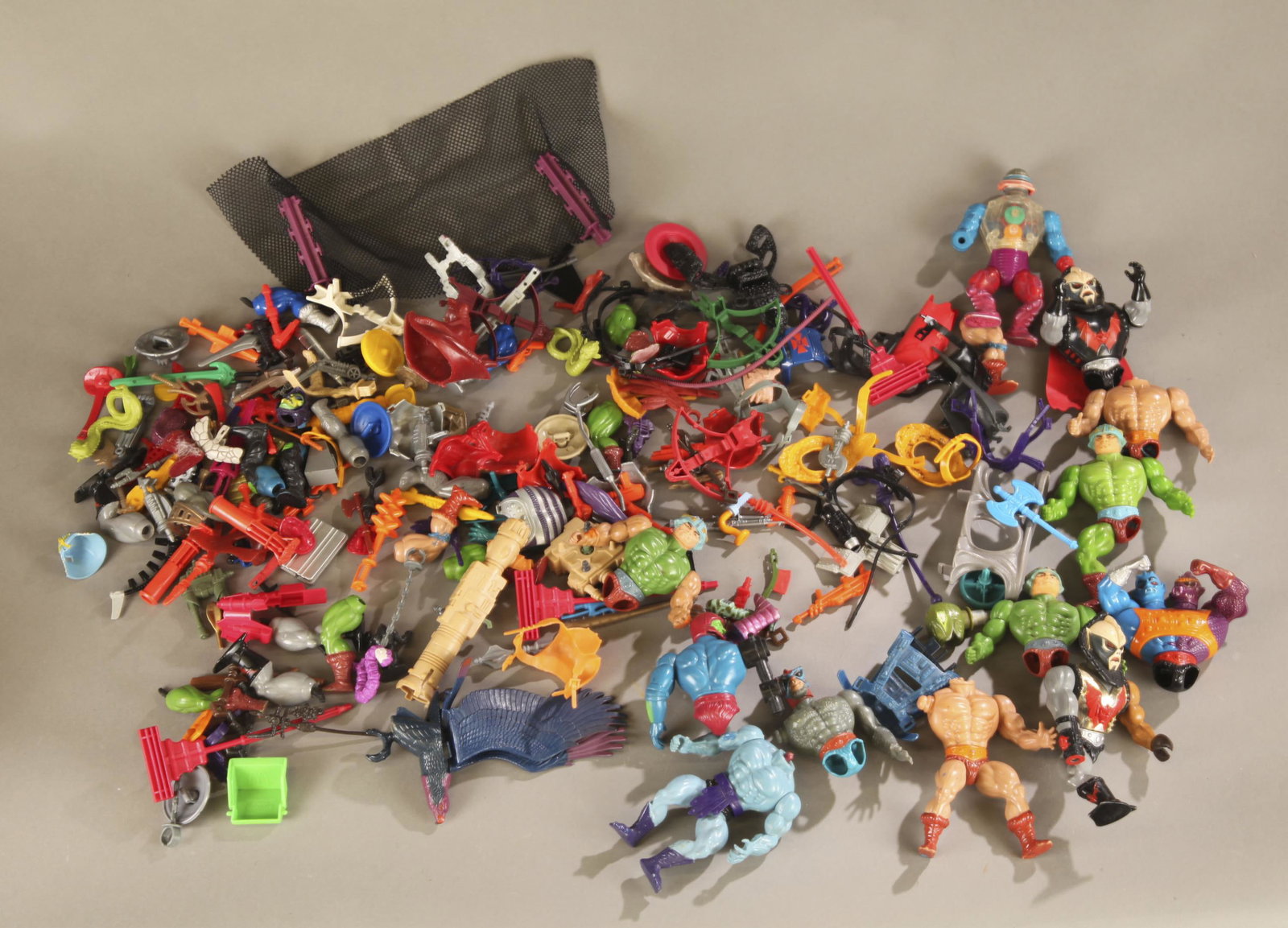 12 broken MOTU action figures and accessories.: A group twelve of broken Mattel Masters of the Universe dolls and accessories. Including armor, weapons, and others. 5 1/2" tall.