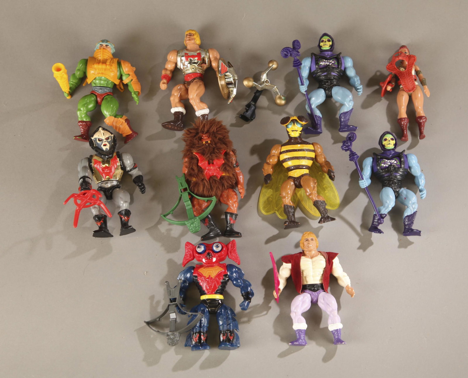 10 loose MOTU action figures.: A group of ten loose Mattel Masters of the Universe action figures. ++ Two 1984 incomplete Battle Armor Skeletor action figures. Including Havoc staff. ++ 1986 incomplete Flying Fists He-Man action fi