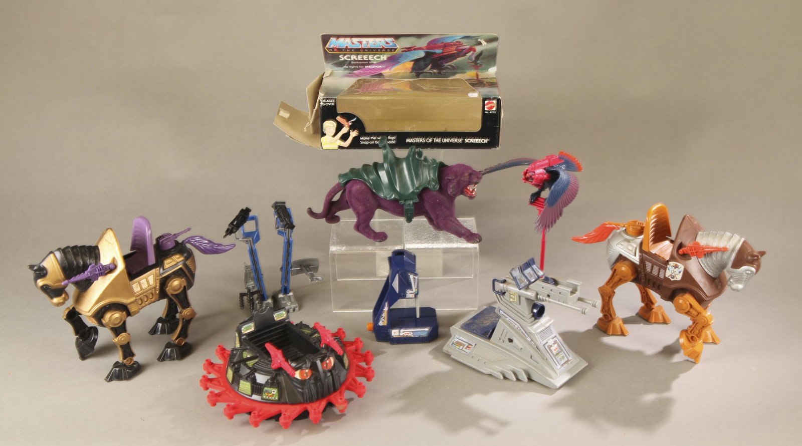7 MOTU vehicles and accessories.: A group of seven Mattel Masters of the Universe vehicles and accessories. ++ 1983 complete Panthor figure with saddle ++ 1983 complete Screech in original box Box 7 1/2" x 10" x 4 1/2" ++ 1984 Rotan v