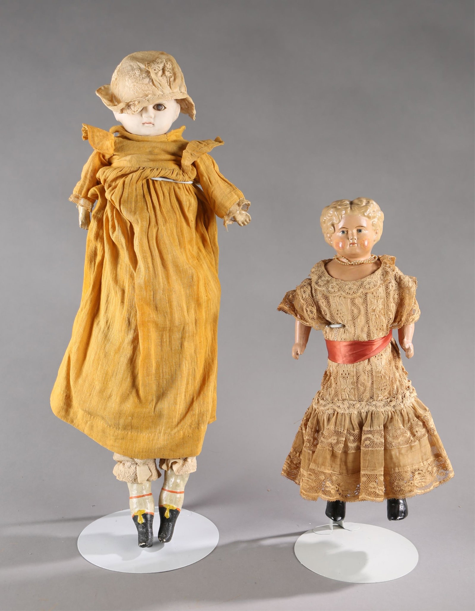 2 Paper mache dolls.: A group of two paper mache dolls. ++ Paper mache doll. Molded hair on shoulder head with curly hair. Cloth body with paper mache limbs. Includes bloomers, petticoat and dress. 15 1/4". ++ Paper mache 