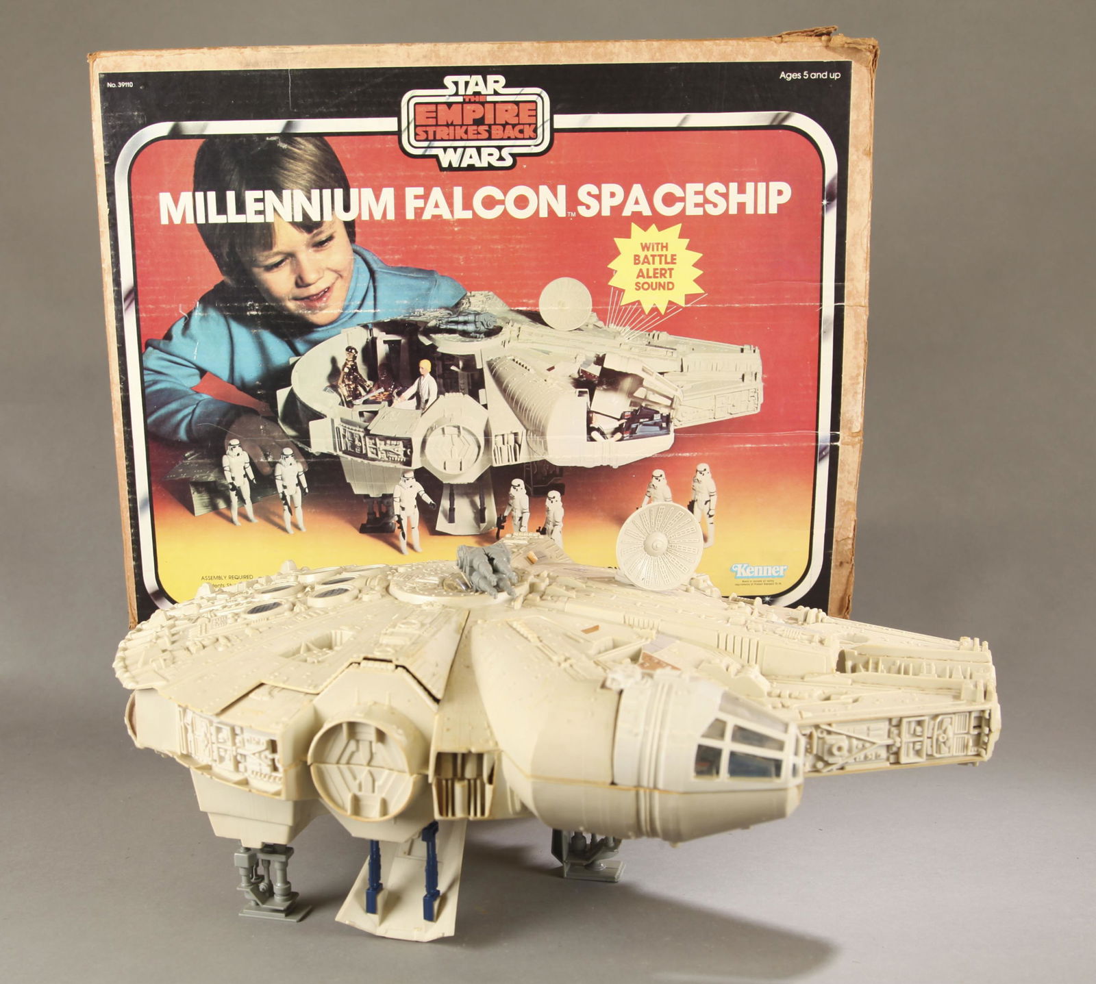 Star Wars: TESB Millennium Falcon with box.: Kenner Star Wars: Empire Strikes Back Millennium Falcon vehicle in original box. Missing chess table and lightsaber practice globe. Ship 20" long. Box: 17" x 22" x 6" Condition: Discoloration consiste