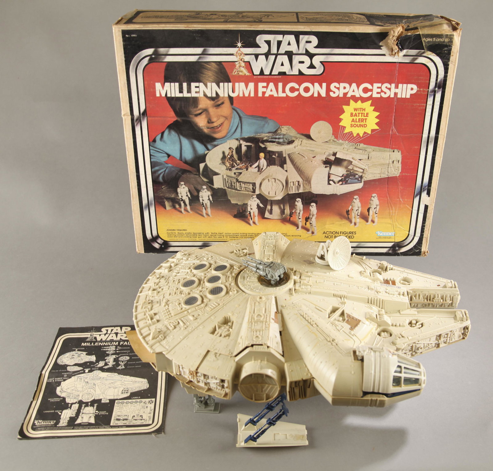 Star Wars Millennium Falcon with box.: Kenner Star Wars 1979 Millennium Falcon with original box. Missing engine decal. Mostly complete. Includes chess table, two struts, lightsaber practice globe, and trap door. Ship 20" long. Box: 17" x