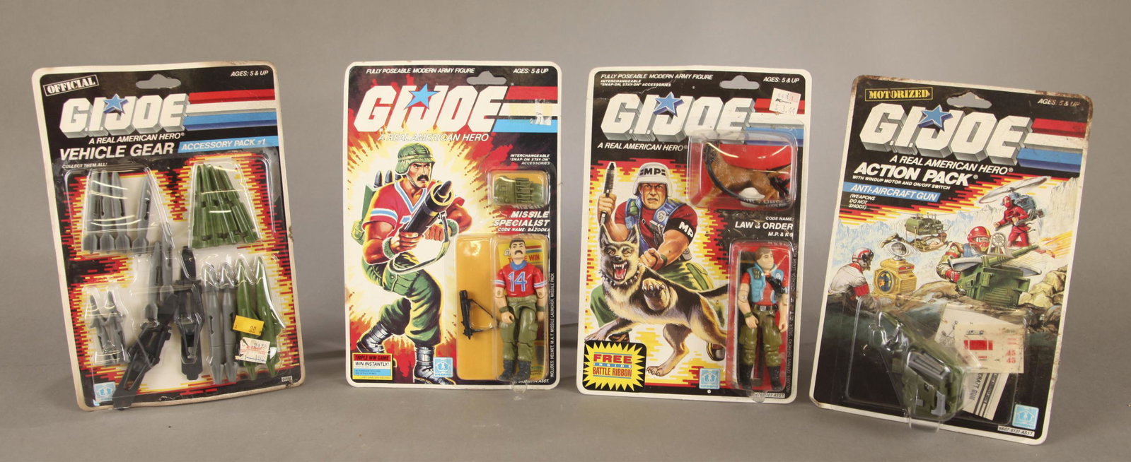 4 G.I. Joe figures and accessories packs MOC.: A group of four Hasbro G.I. A Real American Hero Joe 3.75" figures and accessories pack. Punched mint on card. ++ 1985 Bazooka Missile Specialist. 1986 Law and Order M.P. and K-9 figure. 1987 Hasbro A