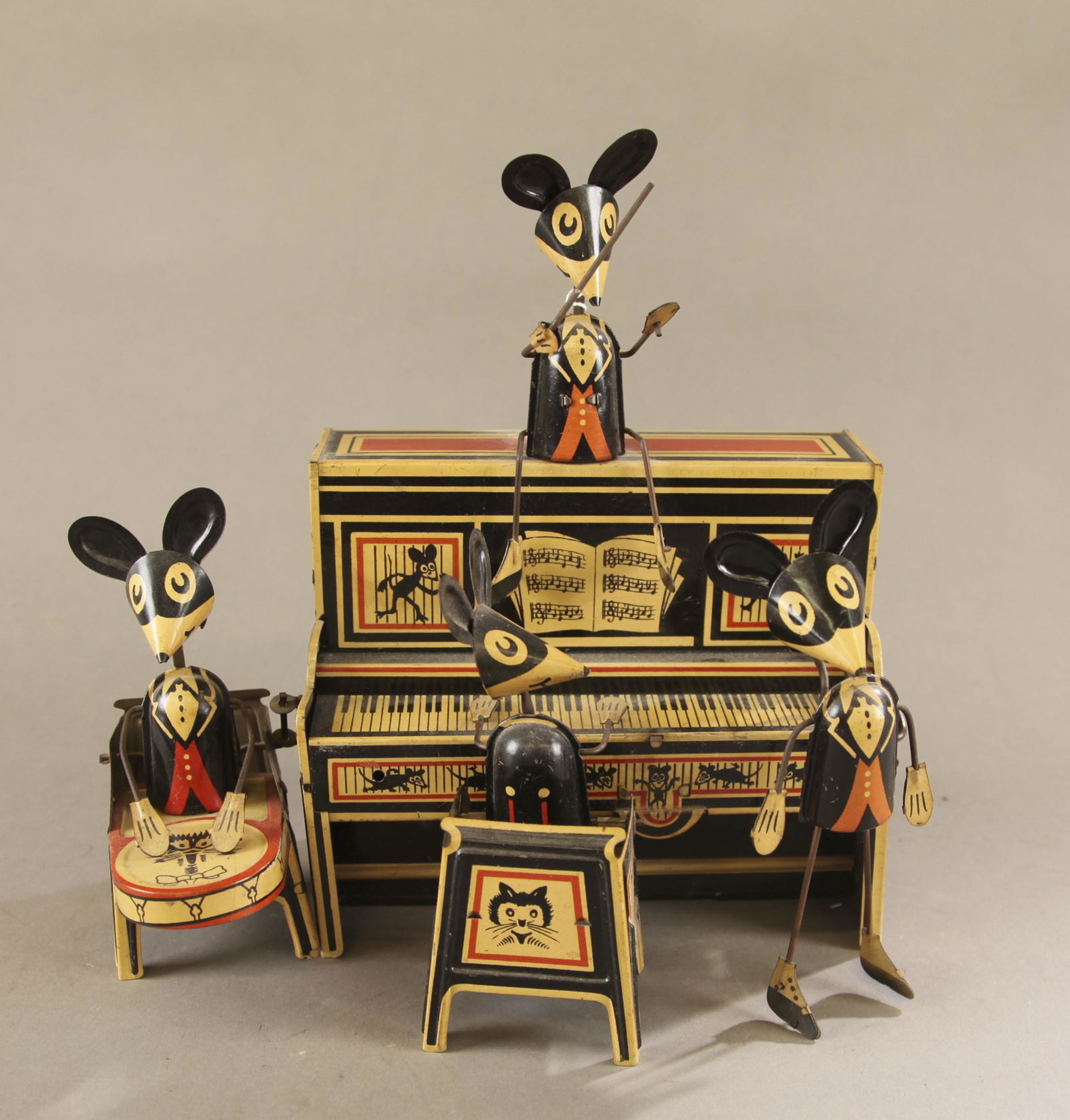 Marx Merrymakers wind-up mouse band.: Marx Merrymakers wind-up mouse band, Circa 1920s. Consisting of a conductor, piano player, dancer, and drum figure. 9" x 9 1/2" x 5". Condition: Light wear and discoloration.Tested functions.