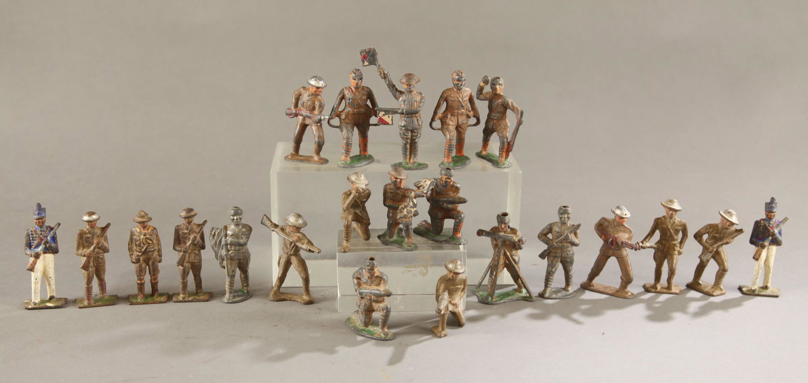 37 dimestore toy soldiers.: A group of thirty seven dimestore toy soldiers and Western Figures. ++ Ten Grey Iron soldiers. Seven WW1 doughboy infantry. Two cadet soldiers. One boy scout. ++ Ten Barclay soldiers. Including stretc