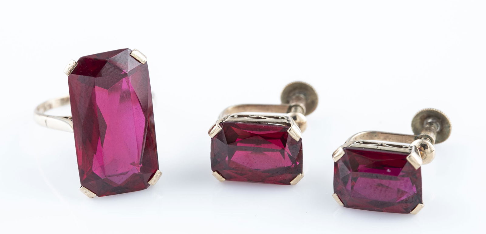 10k synthetic ruby ring and earrings.: A 10k ring and pair of earrings with emerald cut synthetic ruby stones. Stamped on back and inside band. ++.Non-pierced screw back earrings. 1/2". 4.7g. ++ Ring. Size 4. 4.1g.