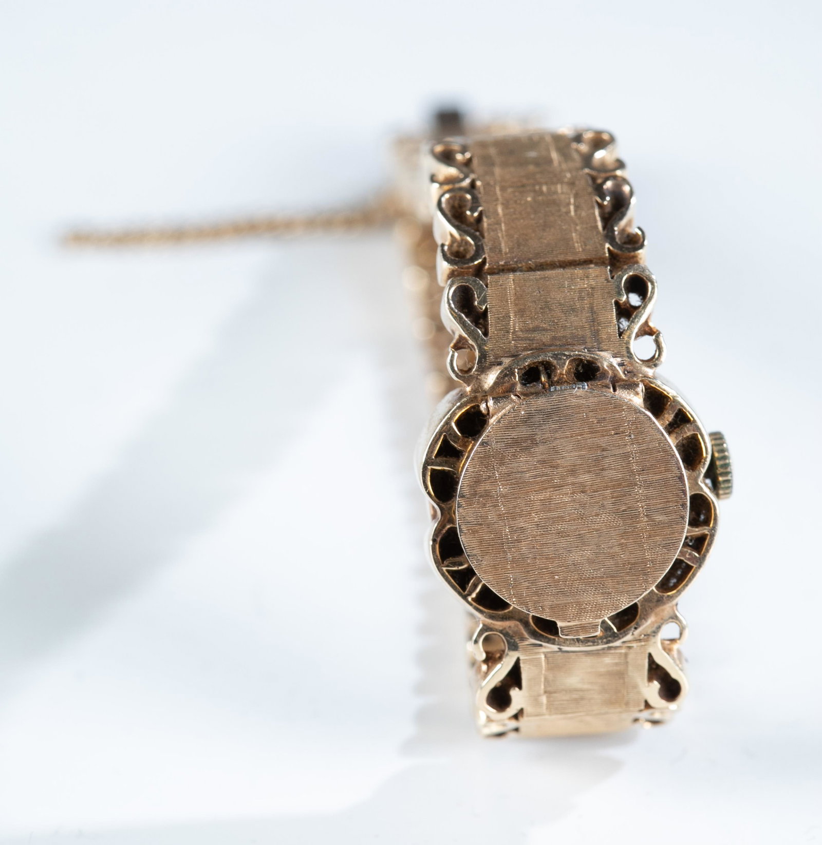 14k Catena watch.: A Catena watch in a 14k yellow gold case and brushed gold link bracelet with a snap lock clasp. Stamped on clasp and back of case. 7". 49.8g. Watch not currently working.