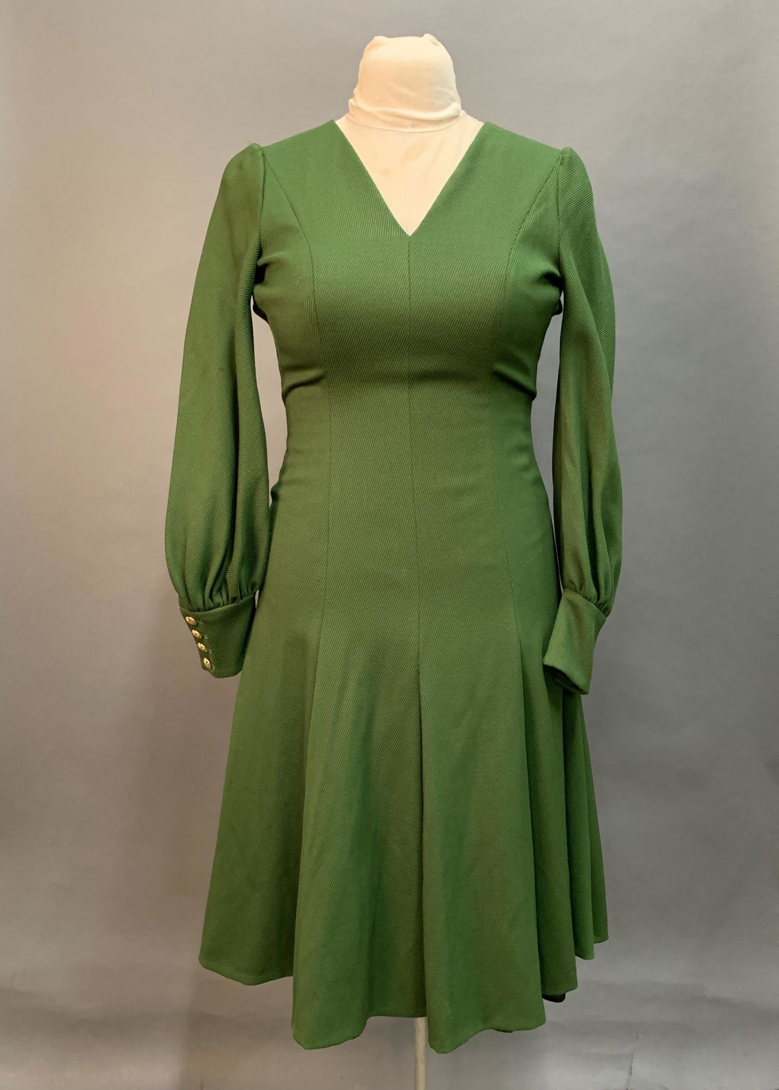 Escada Dress.: An Escada green A-line ribbed dress with gold button sleeve. Exposed zipper. Size 34.