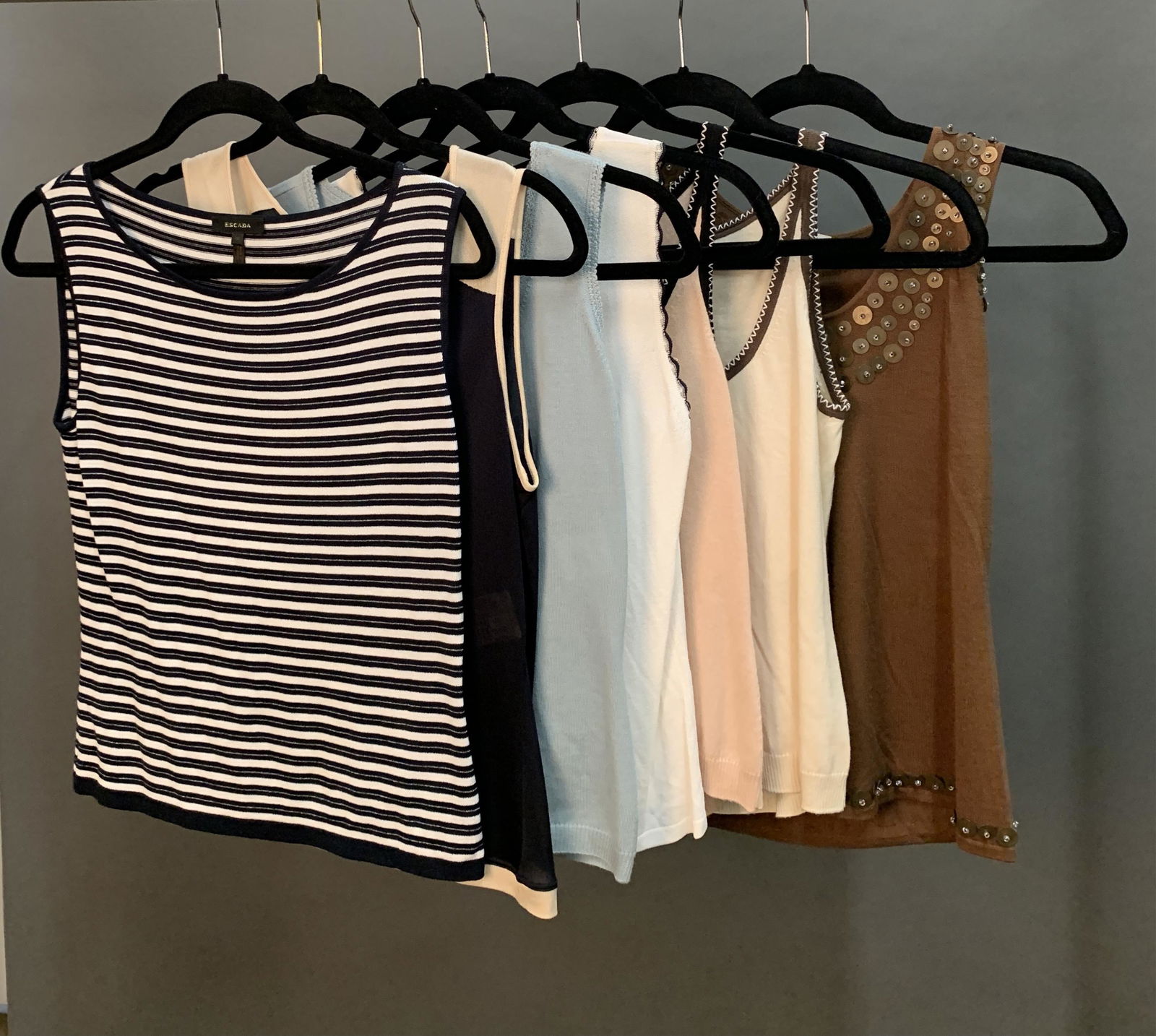 7 Escada Tank Tops.: A group of seven Escada tank tops. ++ Four size 36 tank tops. Navy blue and white striped, navy blue and cream detail, baby blue wool with embroidered detail, white and black embroidered piping. ++ Th