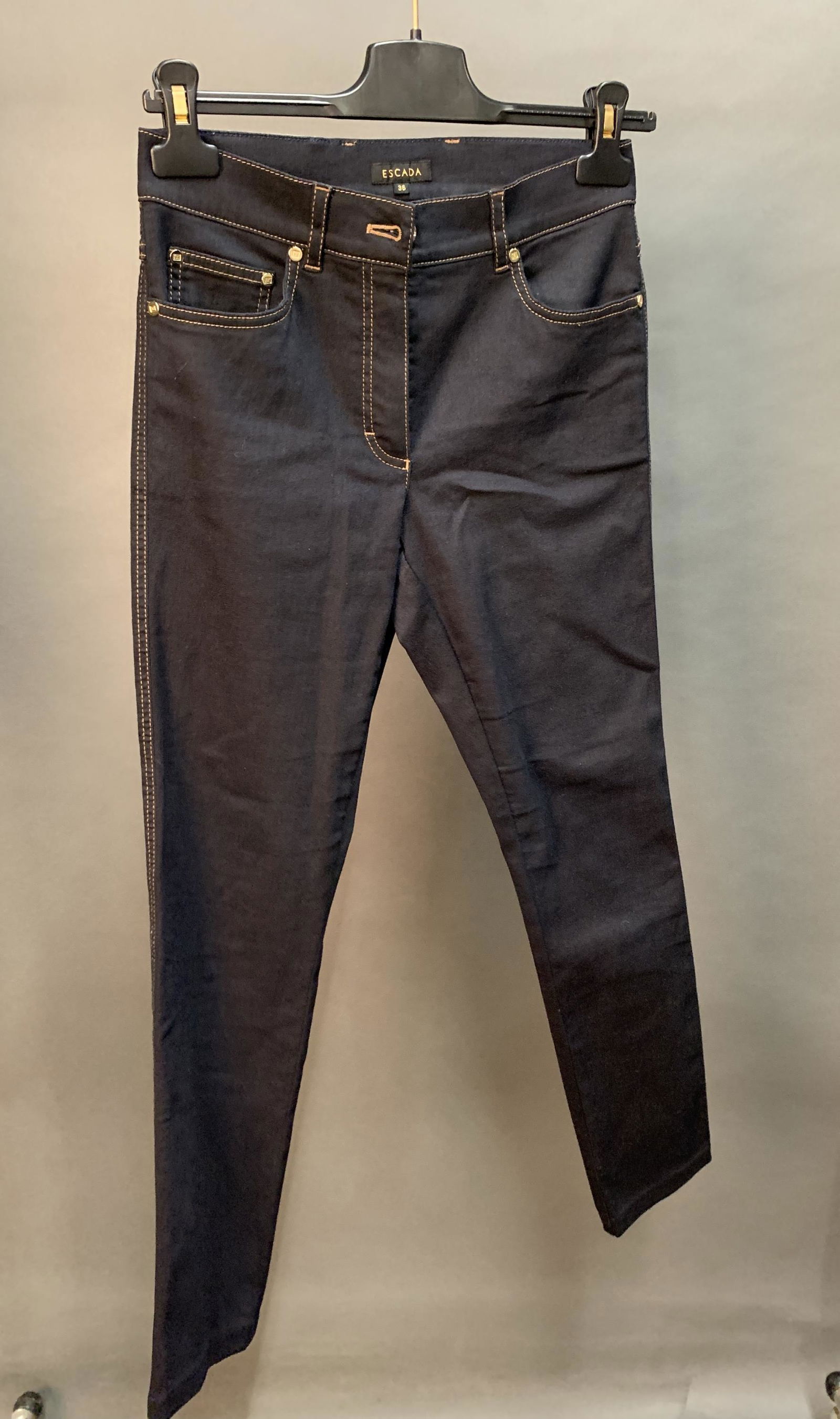 6 Pairs of Escada Pants.: A group of six Escada pants. Size 36. ++ Black with a tuxedo draw waist. ++ Cream wide legged pants. ++ Khaki belted wide legged pants. ++ Brown wide legged pants. ++ Two pairs of jeans.