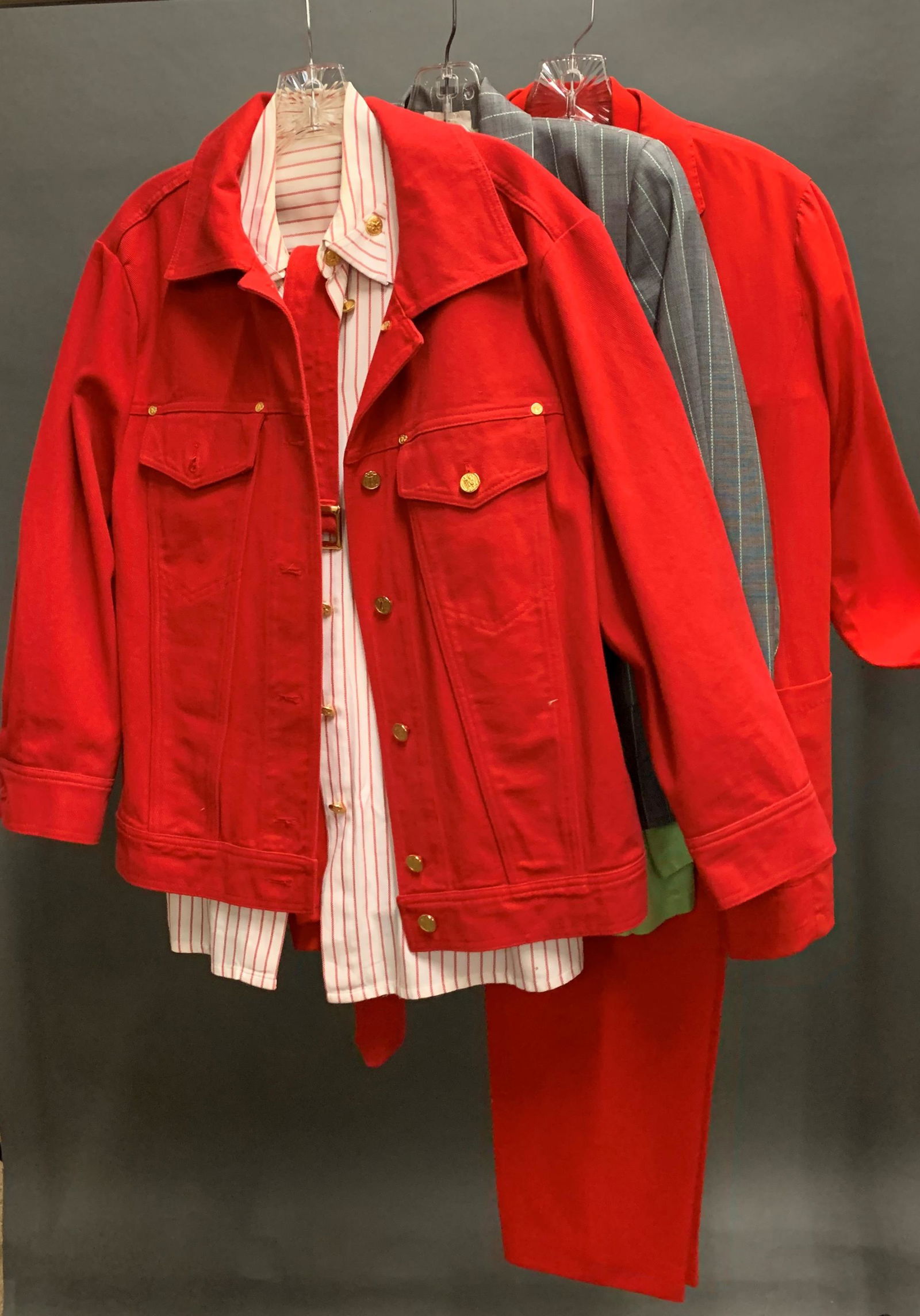 3 Escada Suit Sets.: A group of three Escada suit sets. ++ Gray and green pinstripe blazer (Size 42) with green silk long sleeve button up and gray pinstripe pants (Size 42). ++ Red wool blazer and pants (Size 38) with co