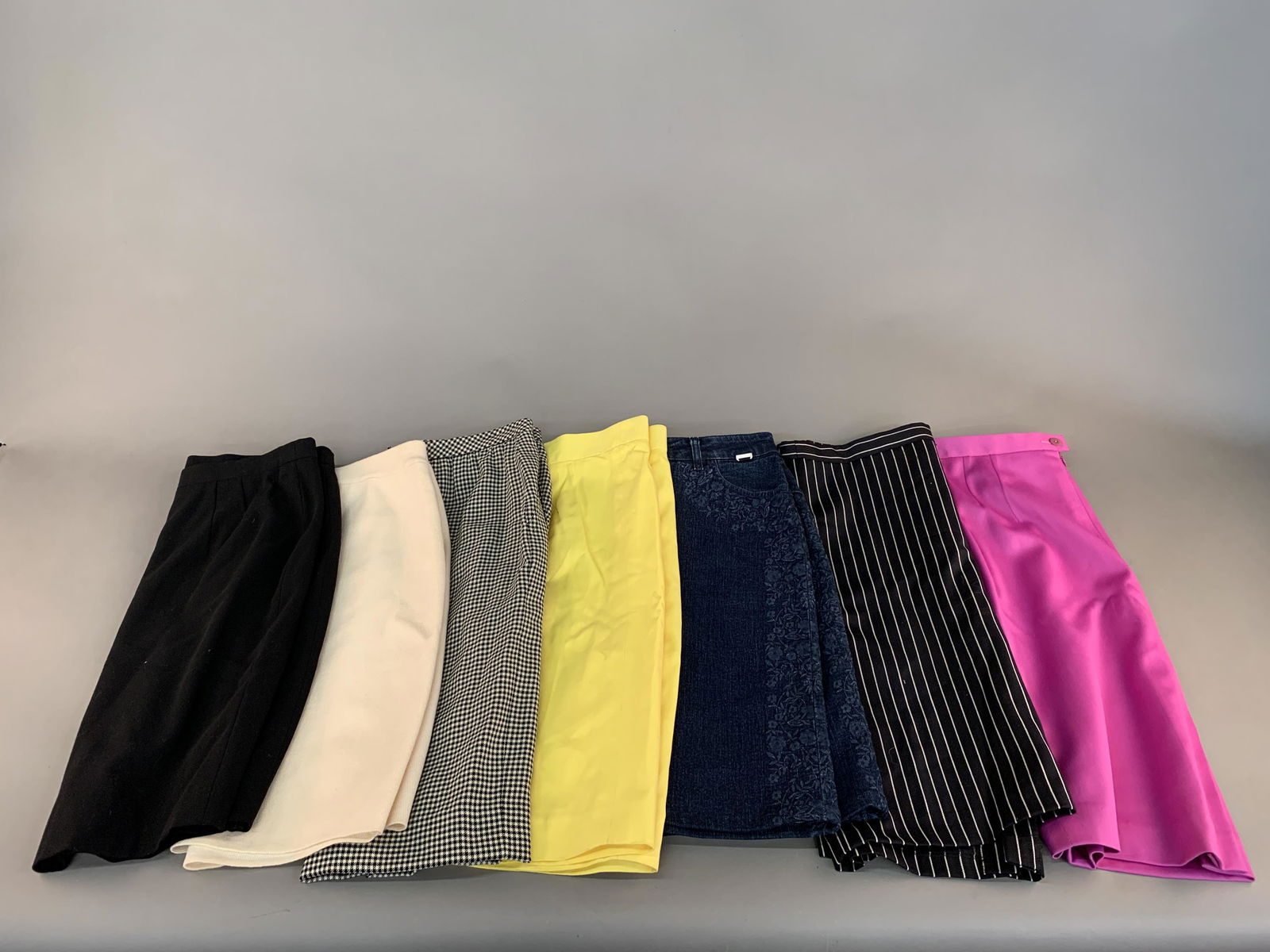7 Escada Pencil Skirts.: A group of seven Escada pencil skirts. ++ Black and white stripe wool blend skirt. Size 38. ++ Denim skirt with embroidered sides. Size 40. ++ Magenta wool skirt. Size 40. ++ Yellow cotton skirt. Size