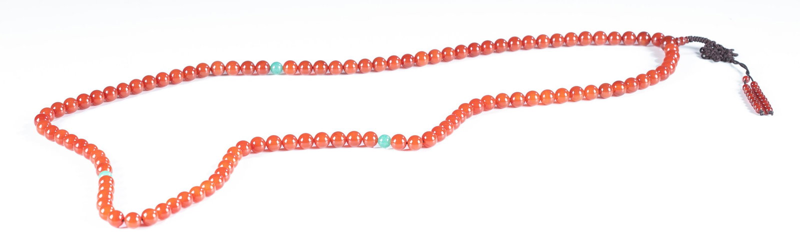 Carnelian beaded necklace.: A large carnelian beaded necklace with a knotted cord pendant. 52". Provenance: The Estate of Giraud V. Foster.The Estate of Giraud V. Foster.