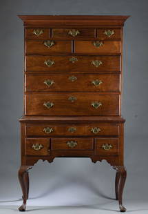 English Queen Anne high boy.: An English Queen Anne high boy, early 19th century. Pine secondary and walnut primary. Eight drawers over four drawers with dust boards. Brass batwing pulls and escutcheons. Carved skirt raised on