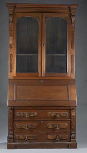 Victorian bureau bookcase.: A Victorian bureau bookcase, 19th century. Pine secondary and oak and burl walnut primary. Break front cornice over two glass doors. Slant front secretary with pigeon holes and three drawers over