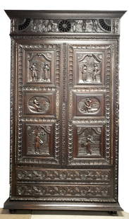 French Brittany style armoire.: A French Brittany style armoire, 19th century. Oak primary. Square crown with pastoral relief and pierced spoke design. Two large doors with six pastoral scenes carved relief panels on two doors with