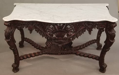 Louis XV style console table.: Louis XV style marble topped console table. Carved and pierced skirt with central shell motif surrounded by flowers. Cabriole legs with rocaille flourishes on scroll feet with stretcher with