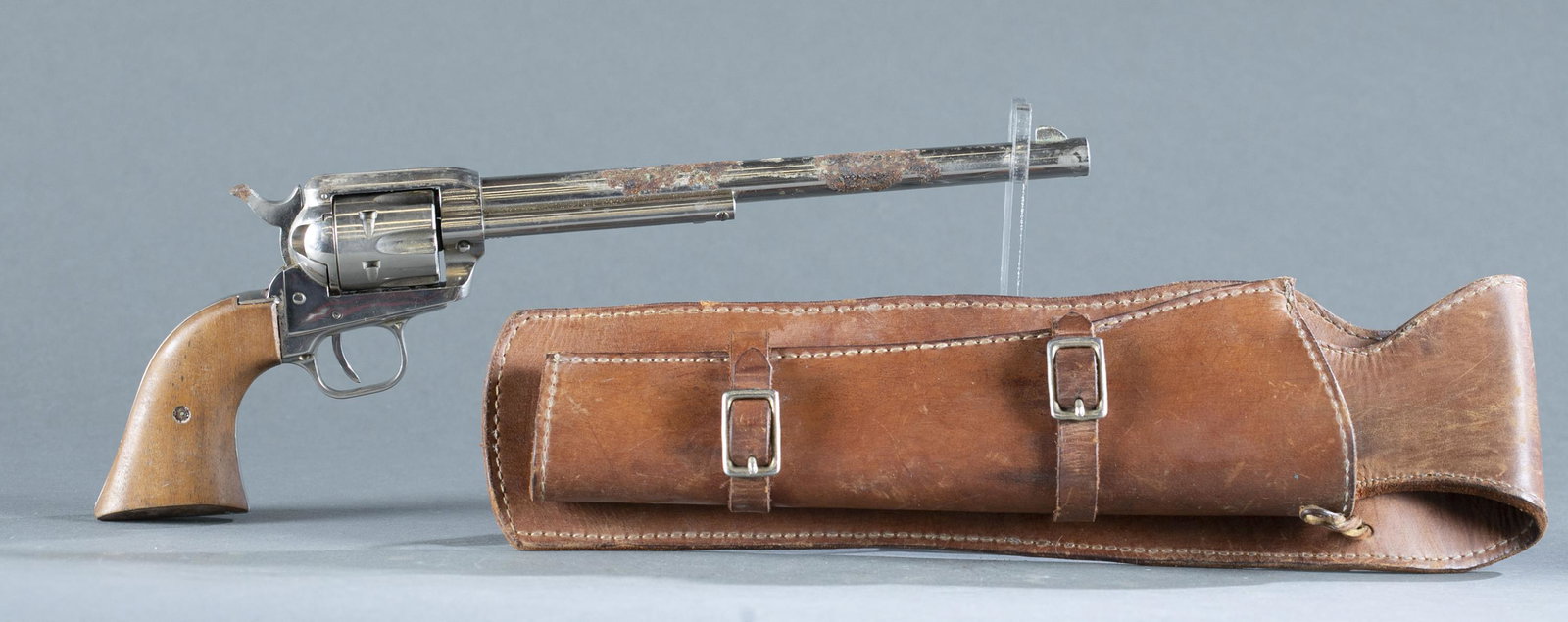 Colt Buntline Scout revolver, .22 magnum.: 1962 Colt Buntline Scout single action revolver, .22 magnum. 9 1/2" barrel. Nickel finish. Walnut grips. Serial 174**K. 14 1.2" overall. Includes leather holster. THIS IS A MODERN FIREARM. IT REQUIRES