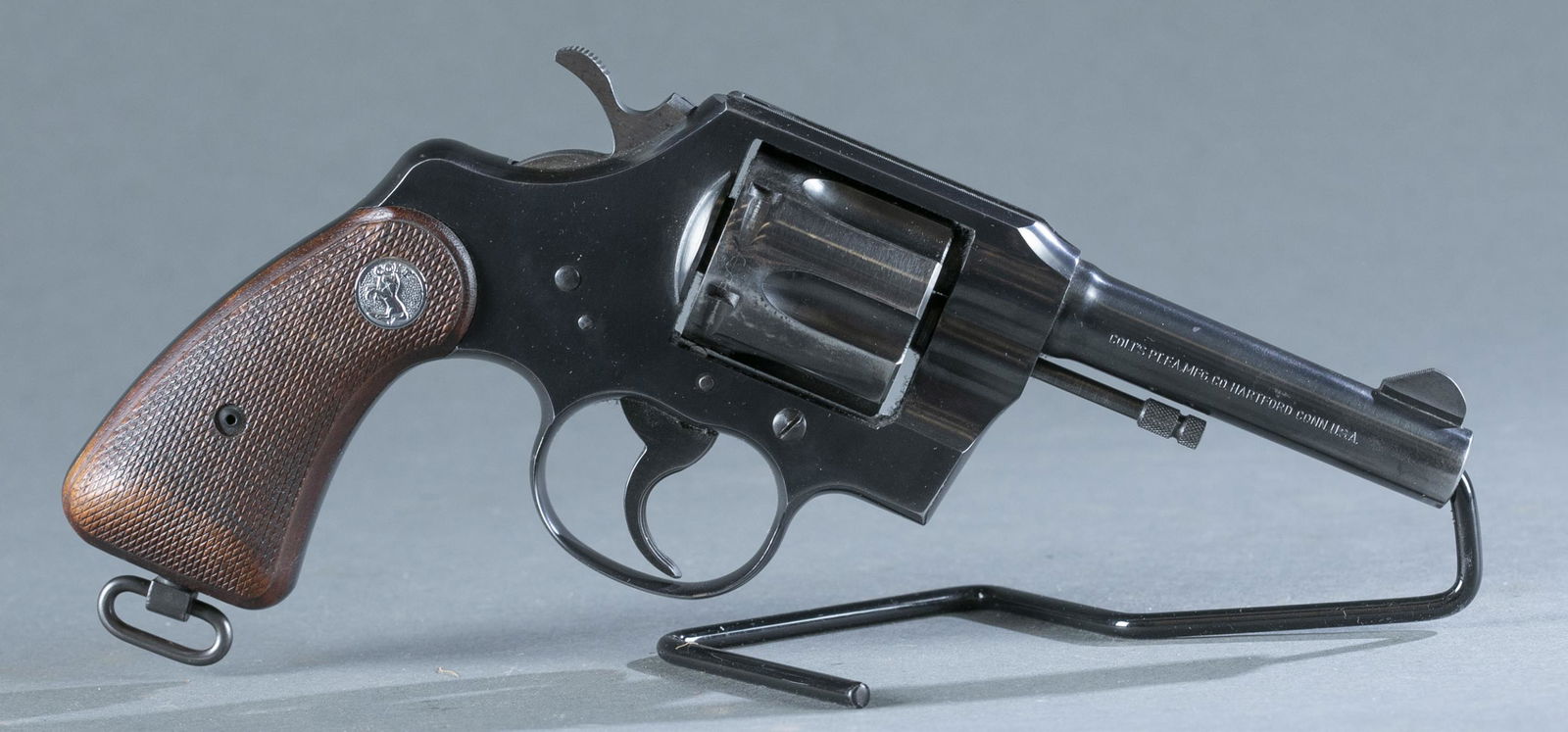 Post-War Colt Official Police revolver, .38 Spl.: Post-War Colt Official Police double action six shot revolver, .38 Special. Circa 1956. Blued finish. 4" barrel. Checkered walnut grips. Serial 8489**. 9" long. Curio or Relic FFL eligible. THIS IS A