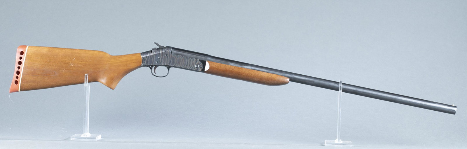 H&R Topper M148 single shot shotgun, 12 gauge.: Harrington and Richardson Topper M148 single shot shotgun, 12 gauge. 28" blued barrel. Case hardened action. Walnut semi pistol grip stock with beavertail fore end. Serial AG293474. 43" overall and 13