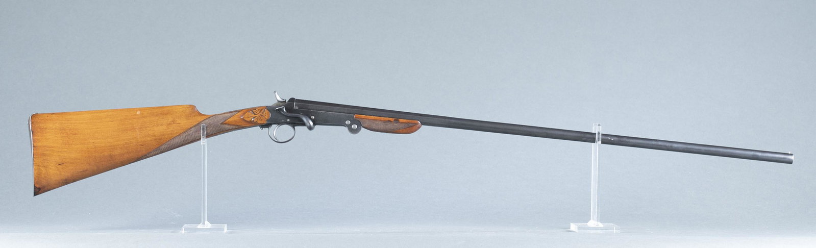 Unusual Belgian single barrel shotgun, .32 gauge.: Unusual Belgian single Poachers folding shotgun, .32 gauge. 2 9/16" chamber. Post 1924. Blued 29 1/2" barrel. Leige and Nitro proof marks. Birch straight wrist stock with checkered wrist. Serial 2100.