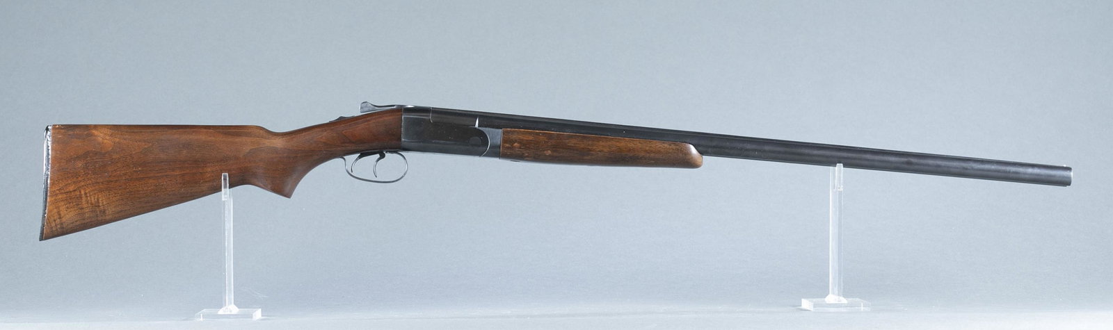 Winchester M24 sxs shotgun, 12 gauge.: Winchester model 24 boxlock side by side shotgun, 12 gauge. 2 3/4" chambers. Circa 1952. 28" blued barrel. Fixed choke full and modified. Blued receiver. Walnut rounded grip stock and beaver tail. 14 
