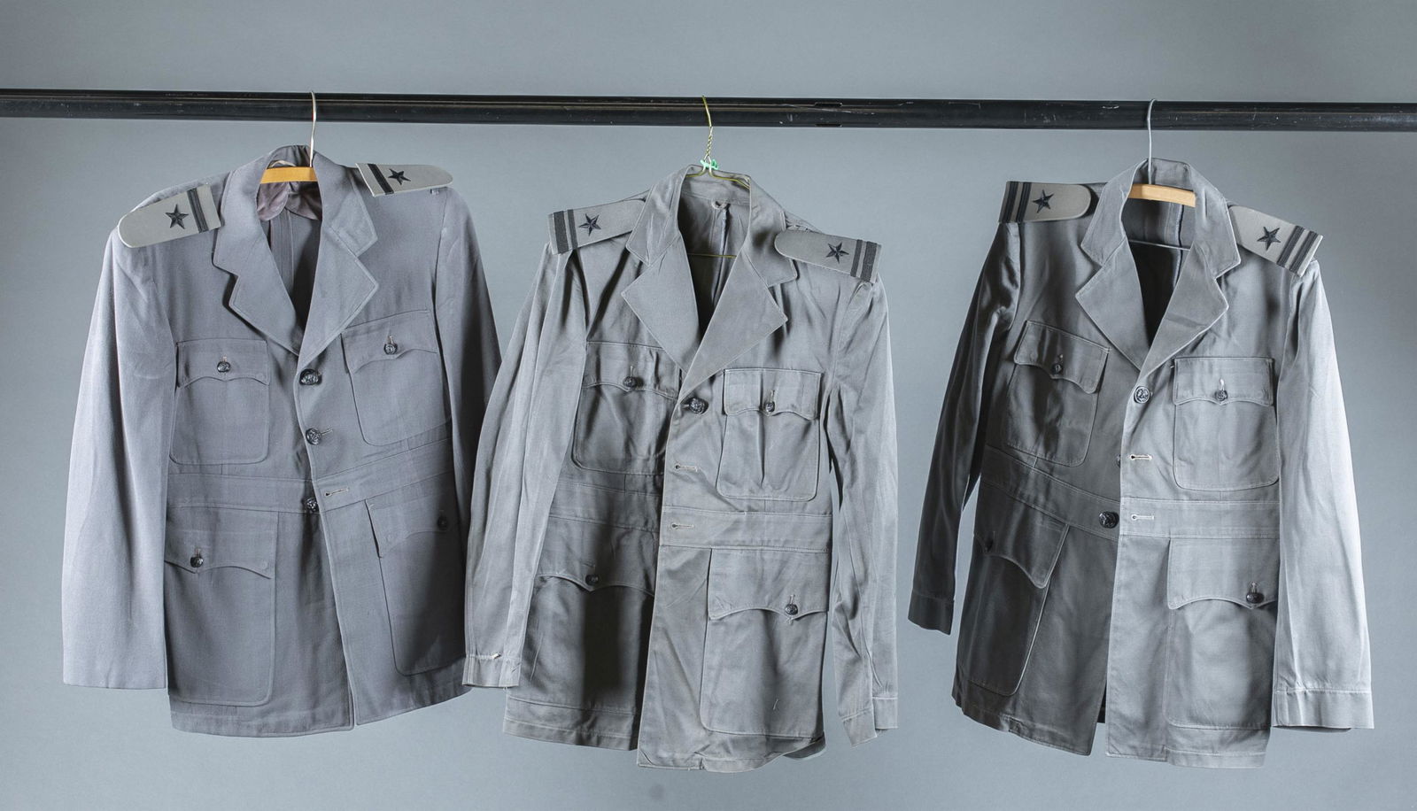 3 WW2 U.S. Navy gray uniform coats.: A group of three WW2 U.S. Navy gray uniform coats, circa 1943-1945. Shoulder rank insignia for Lieutenant, Lieutenant Junior Grade, and Ensign. Condition: Some staining.