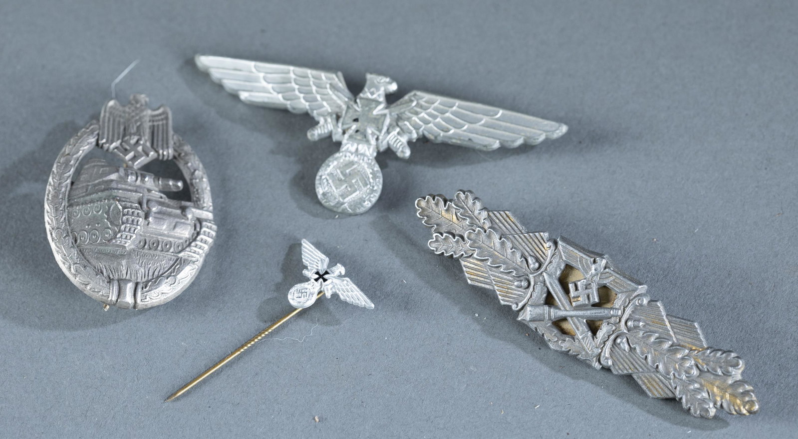 3 WW2 German Wehrmacht badges.: A group of three WW2 German Wehrmacht badges. ++ Waffen SS gilt Close Combat Clasp. Marked reverse "FEC. WE. PEEKHAUS/ BERLIN." Gilt finish heavily worn. ++ The Panzer Badge or Tank Battle Badge. Unma