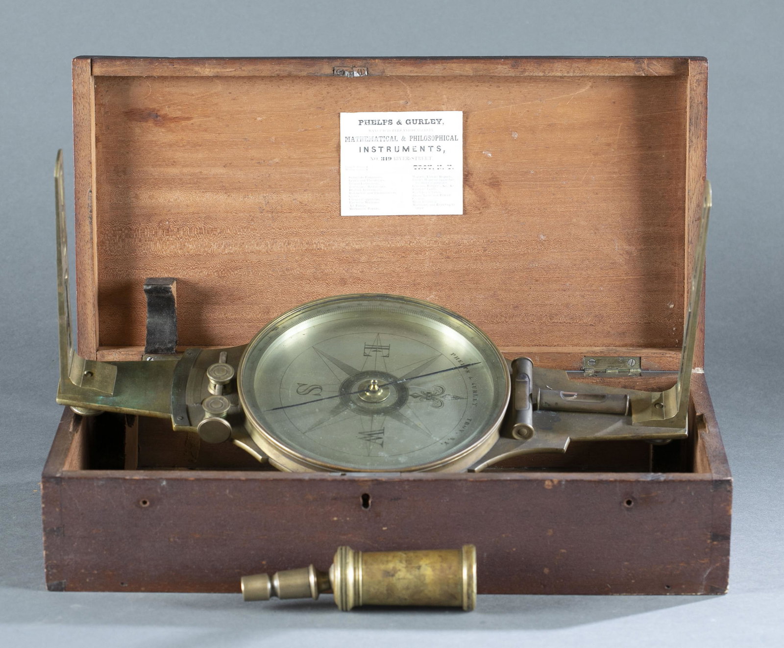 Antique Phelps & Gurley survey compass.: Antique Phelps & Gurley survey compass in case, circa 1845-1851. 15 3/4" long. Includes compass with brass case, two brass vanes with bolts, and ball and socket attachment for leveling. Includes Arhur
