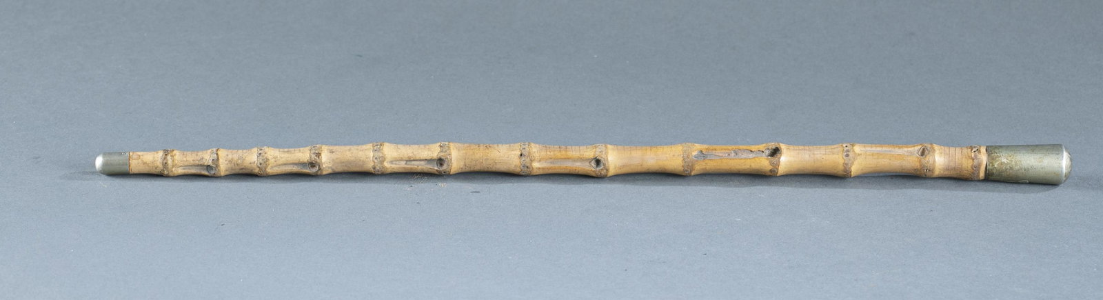 British officer's swagger stick.: King's Own Scottish Borderers officer's swagger stick, 20th Century. Silver top and tip on bamboo stick. 20 1/2" long. Provenance: From the collection of Nicholas R. Burke, Washington D.C.
