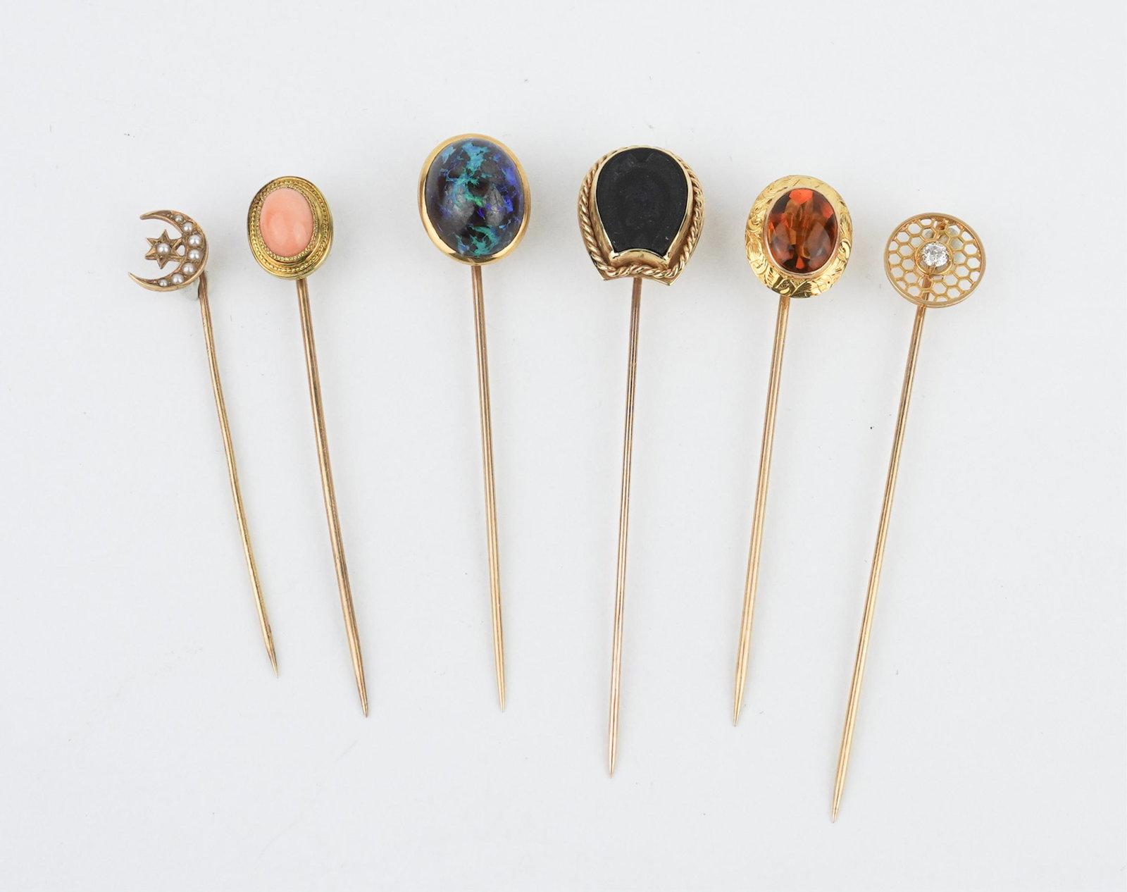 Grouping of Vintage 4KYG and Stone Stickpins: Grouping of Vintage 4KYG and Stone Stickpins to include black onyx intaglio of horse and horseshoe, gross weight approx. 2.55dwt ++ Oval cabochon citrine stickpin, gross weight approx. 1.30dwt ++ Oval