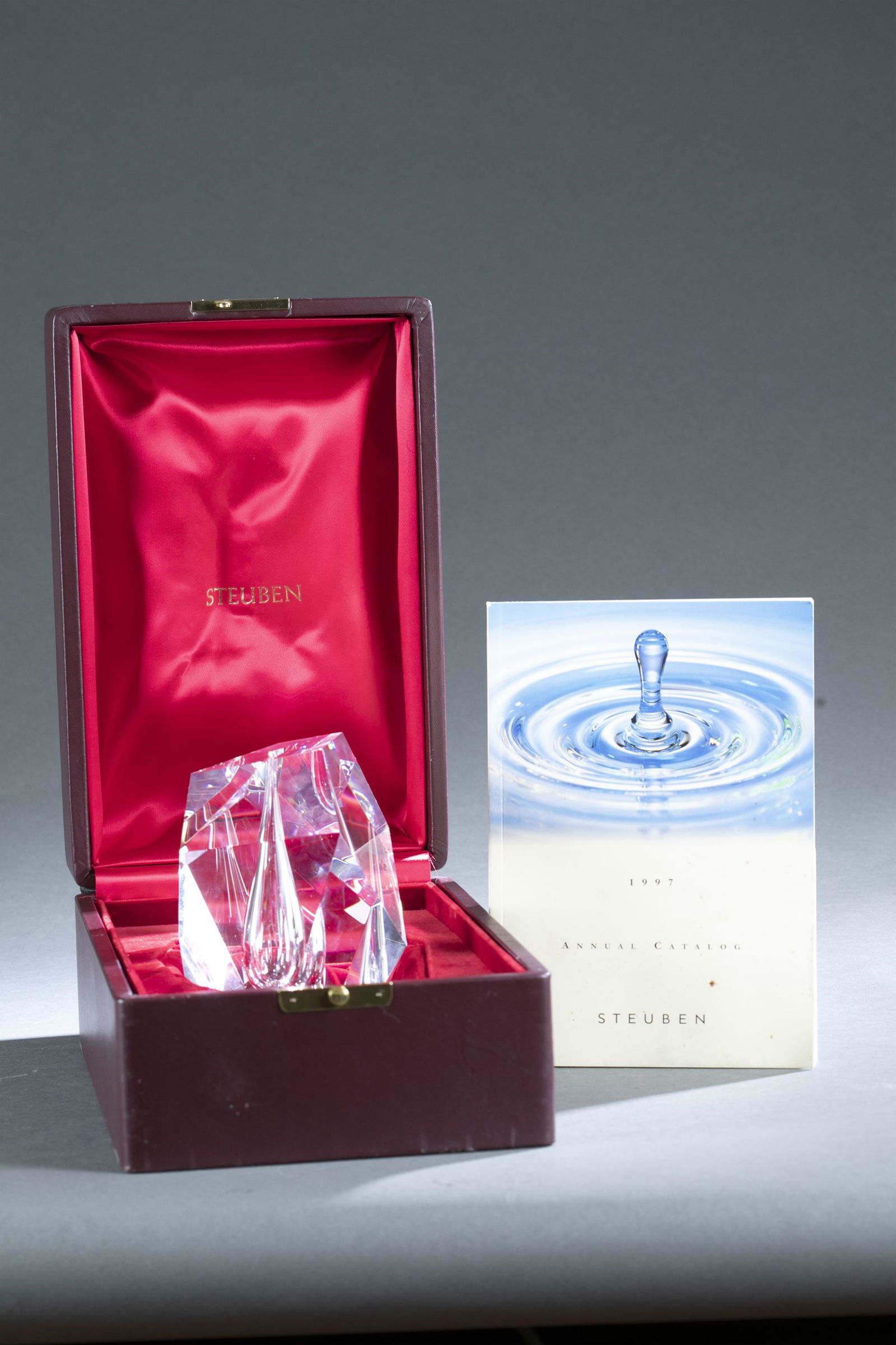 Steuben, "Cut Vase," 1969.: A Steuben "Cut Vase" by Paul Schulze. Diamond cut glass vase with opening for floral picks. 1969. 6 1/4" x 4 1/4". Condition: Smudged. Box and 1997 Catalog included.