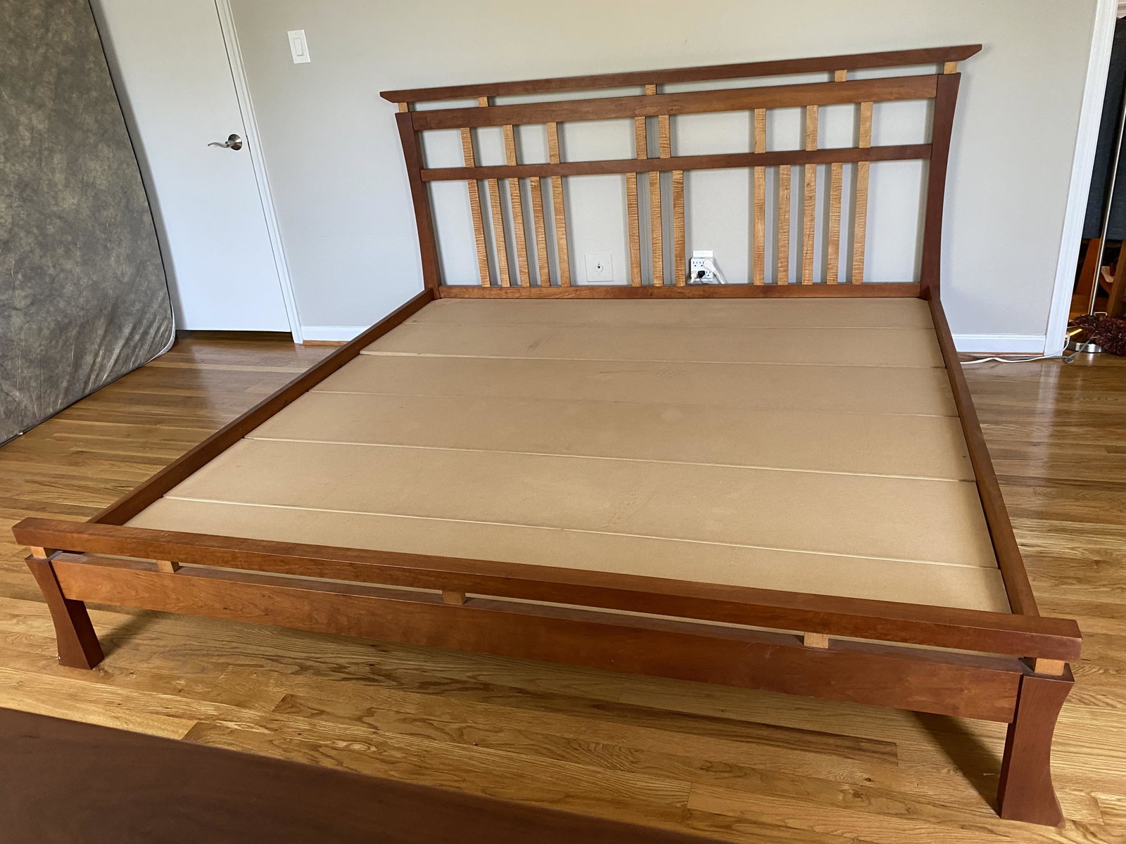 Hardwood Artisans Waterfall bed.: A Hardwood Artisans Waterfall cherry and maple wood King bed. 21st century. Provenance: From the collection of Philippe Hebert. 43 1/2" x 84 1/2"