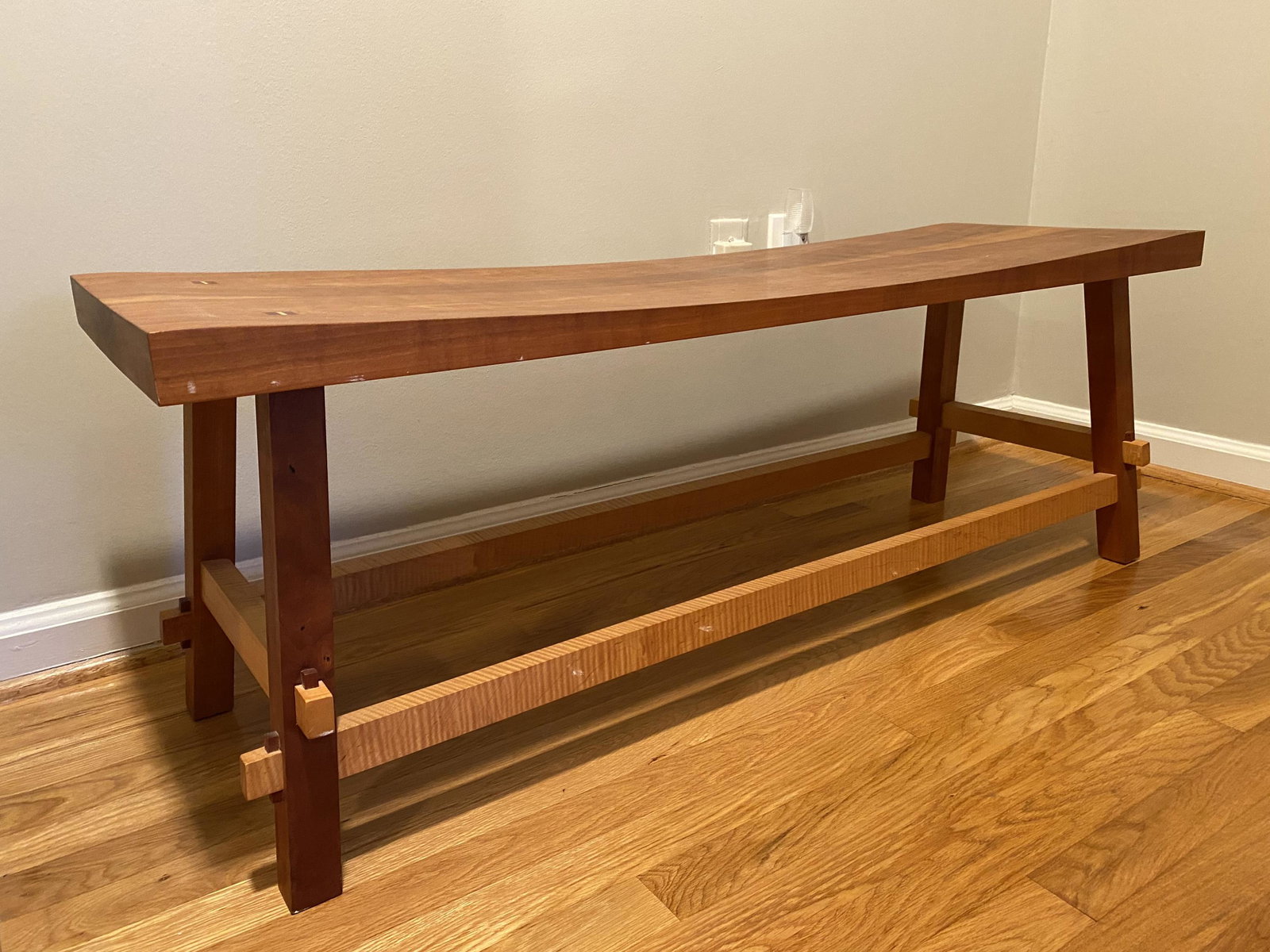 Hardwood Artisans bench.: A Hardwood Artisans Shinto bench in cherry and maple wood . 21st century. Made in Virginia. 17" x 48" x 15" Provenance: From the collection of Philippe Hebert.