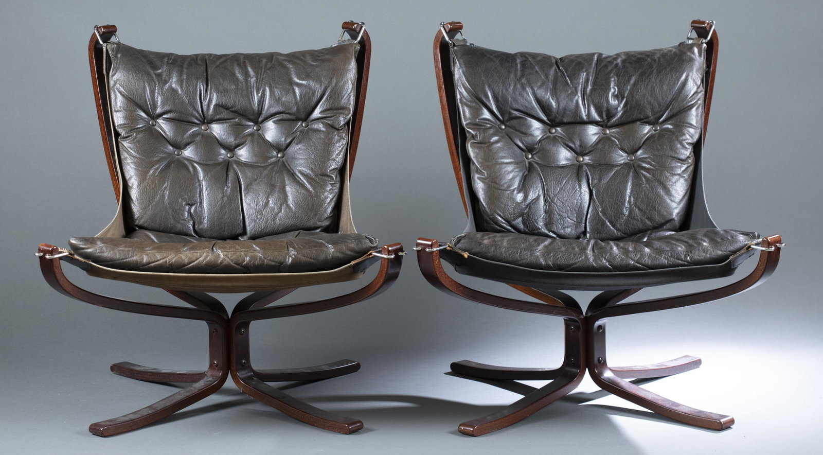 2 Sigurd Ressell Falcon Chairs.: A group of two Falcon Chairs by Sigurd Ressell for Vatne Moble Norway. Black leather button back cushions on black canvas with bentwood frame. Circa 1970s. 32" x 26". Condition: Faded leather and canv