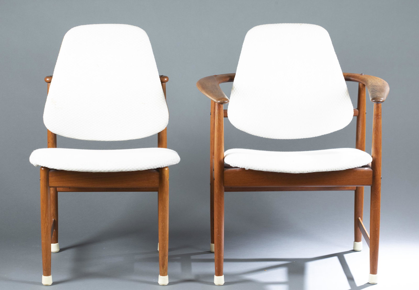 4 Arne Hovmand-Olsen armchairs.: A group of four Danish modern Arne Hovmand-Olsen armchairs with cream textured upholstery and teakwood frame. Marked on bottom. Circa 1960s. Smallest: 33 1/2" x 27". Largest: 33 3/4" x 20". Condition: