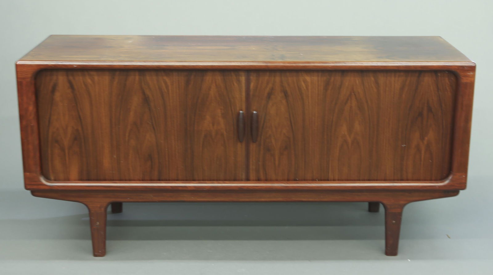 Dyrlund rosewood server.: A Dyrlund rosewood server with tambour doors. 31 1/4" x 65 1/4" x 20 5/8".